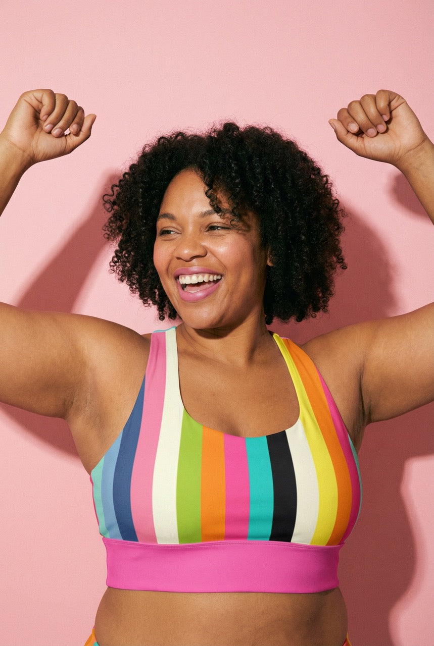 colorful striped sports bra against a pink background