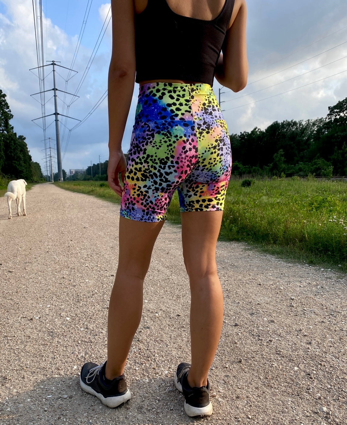Woman wearing colorful animal patterned shorts on a road outdoors