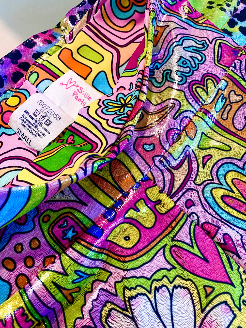 Colorful whimsical patterned glitter shorts with inside tag