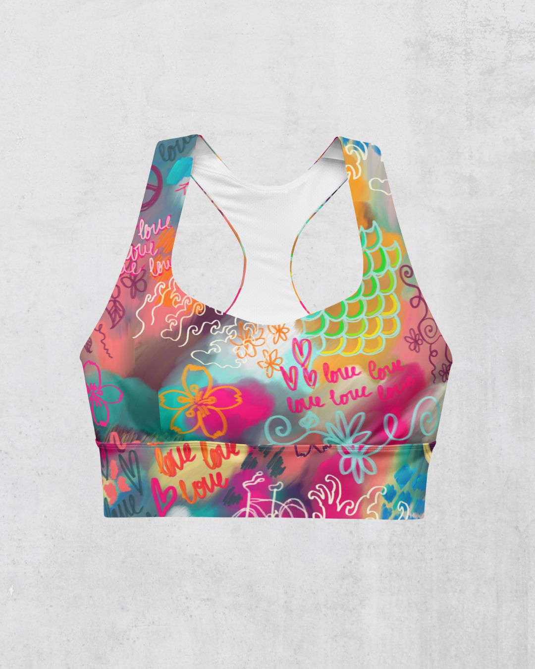 Colorful sports bra with floral and mermaid scale patterns, front view