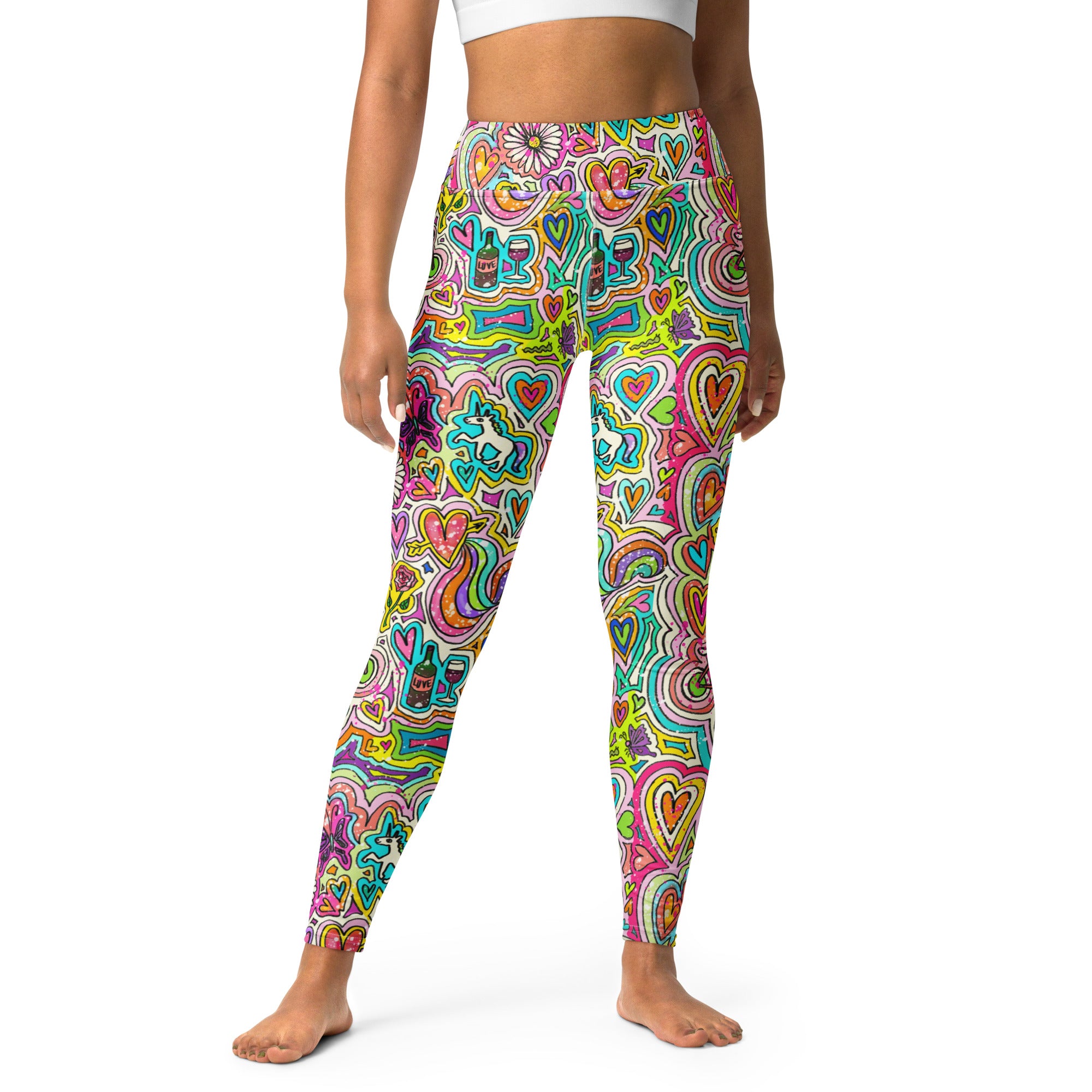 A pair of high-waisted yoga leggings with a vibrant, colorful doodles pattern, front view on person