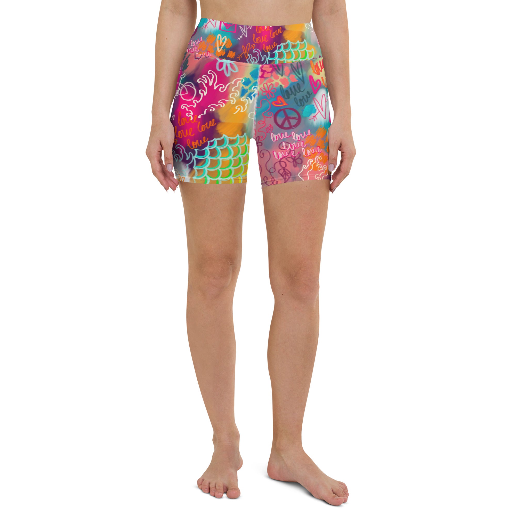 Colorful short yoga shorts with mermaid scales and sakura print front side view on person