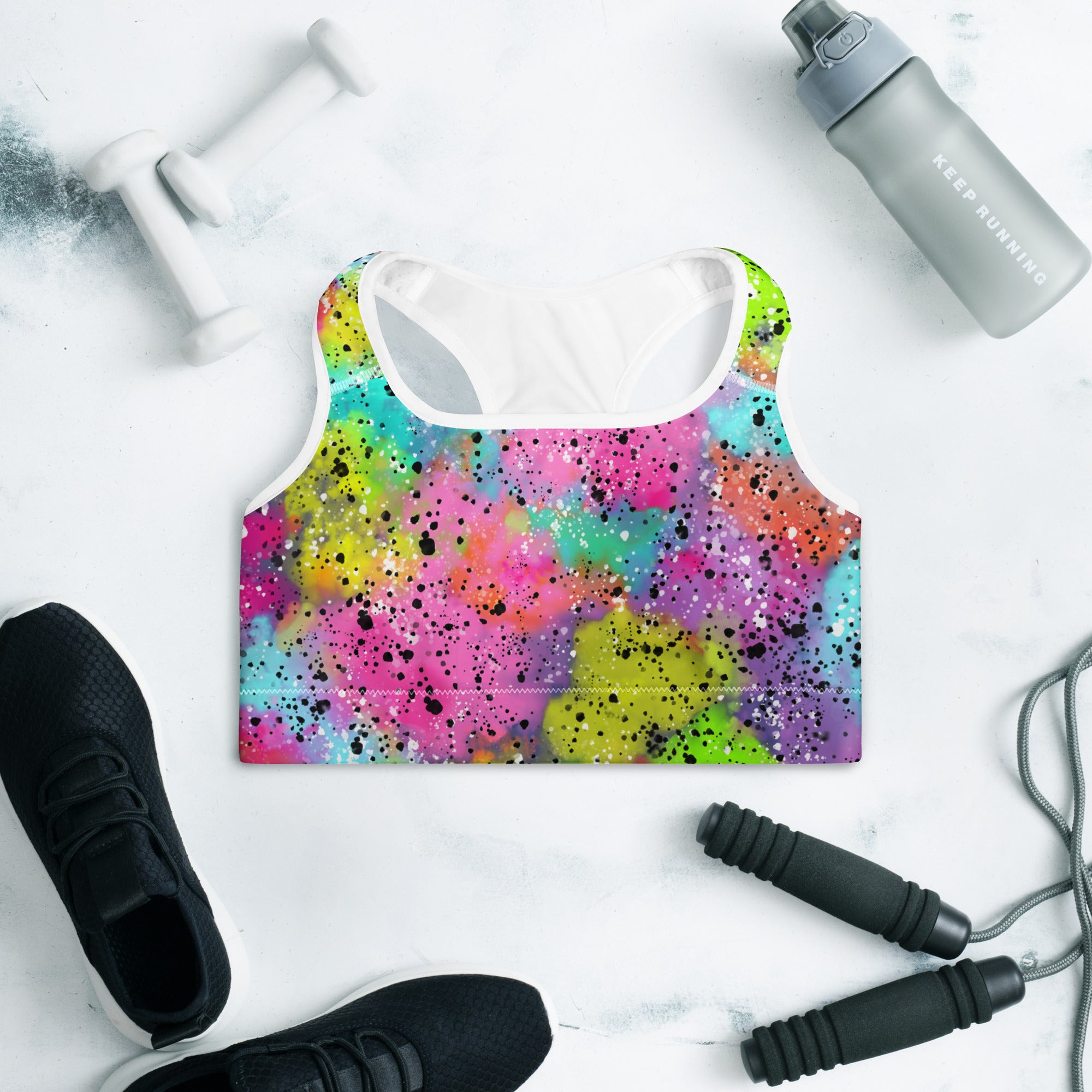 Colorful sports bra with rainbow galaxy print on a flat background, front side