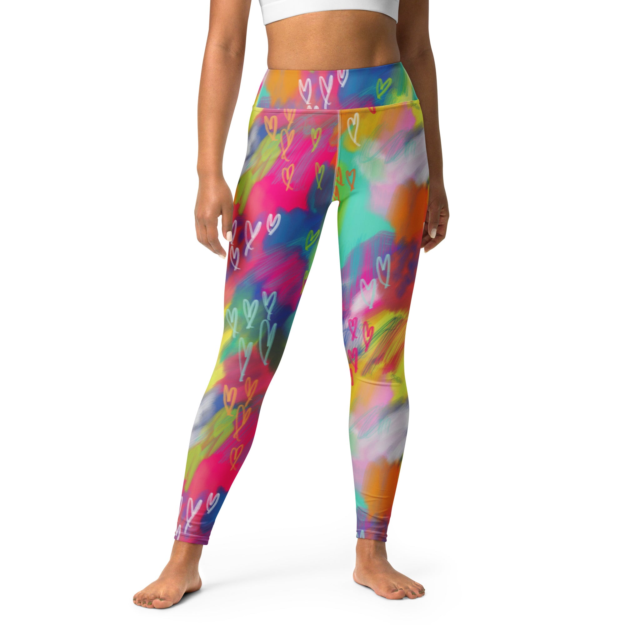 A pair of high-waisted yoga leggings with a vibrant multicolored abstract pattern.
