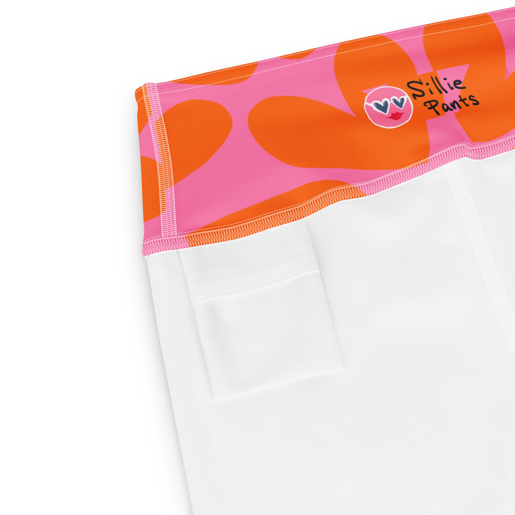 Yoga leggings with pink and orange hearts print and small back pocket at the waistband on a white background