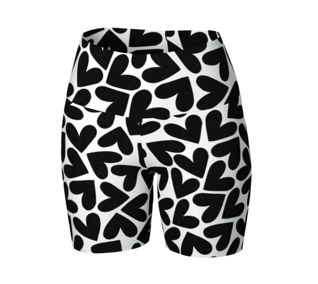 Black and white heart patterned yoga shorts on a white background