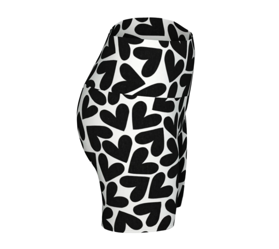 Black and white heart patterned yoga shorts on a white background