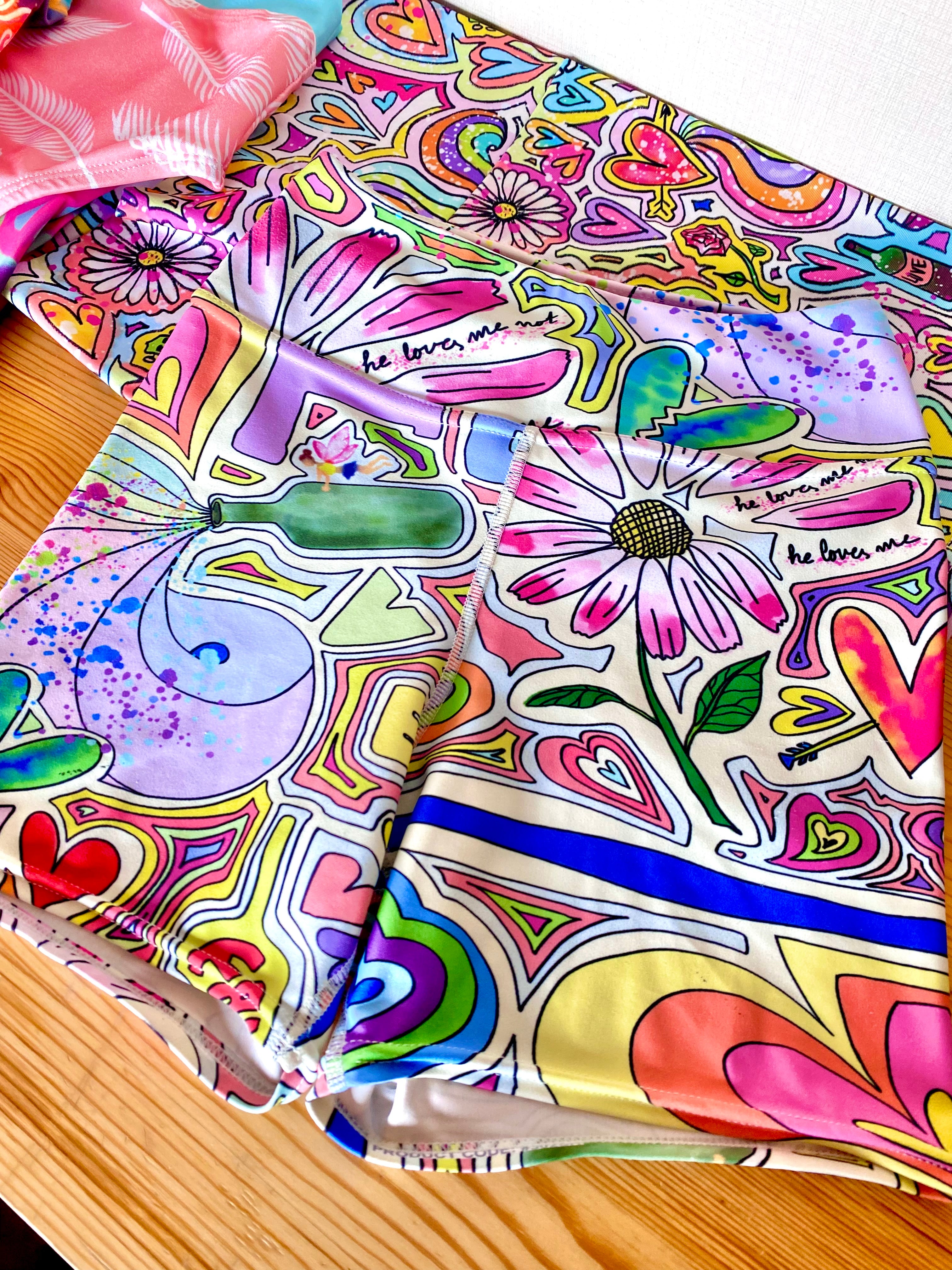 Colorful short yoga shorts laid flat front side, fairy dust print