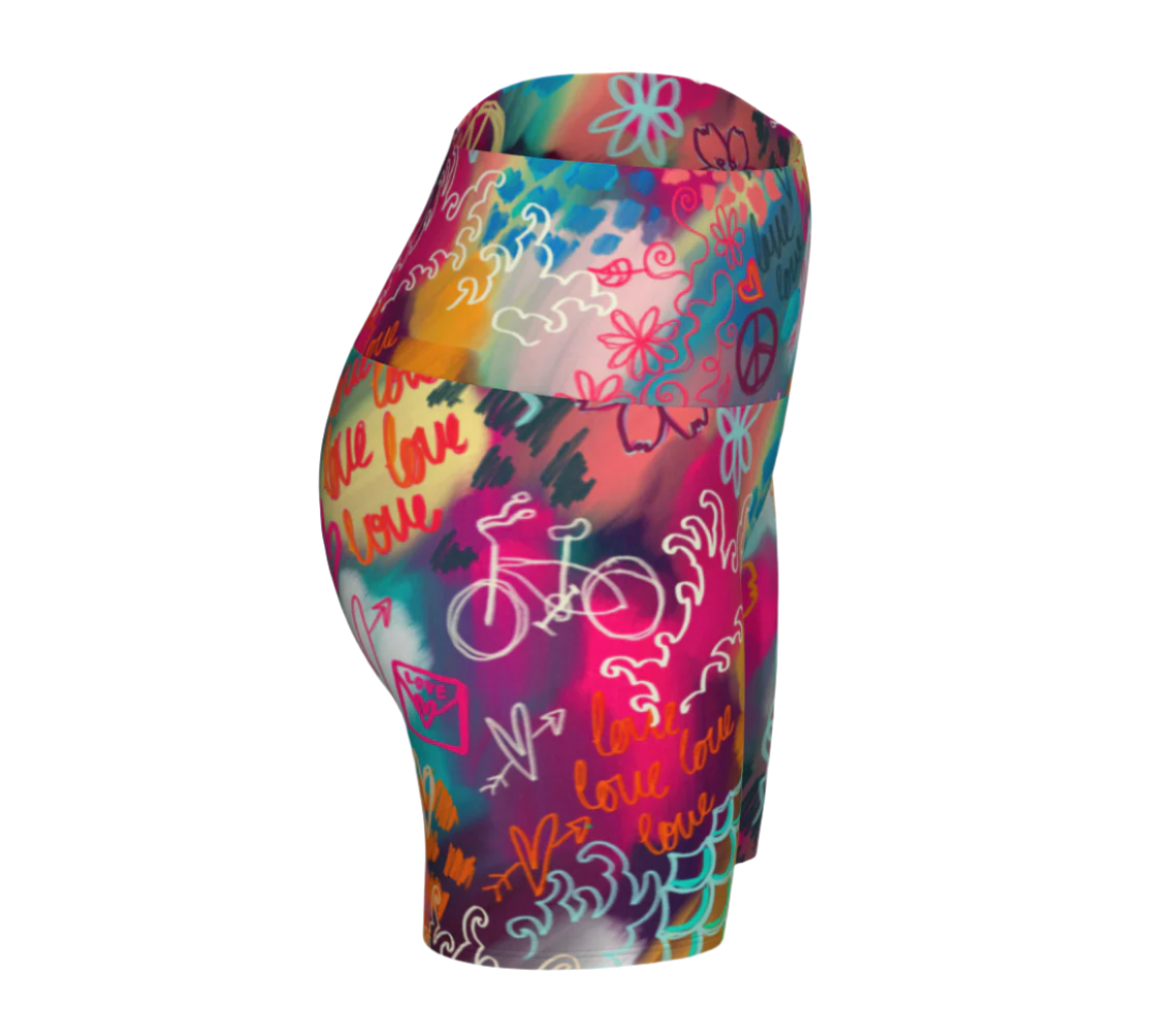 Colorful high-waisted yoga shorts with abstract patterns and text on a white background