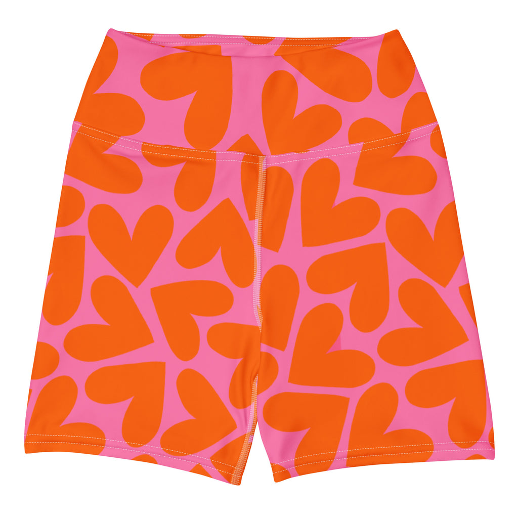 Colorful short yoga shorts with pink and orange hearts print, front side flat view