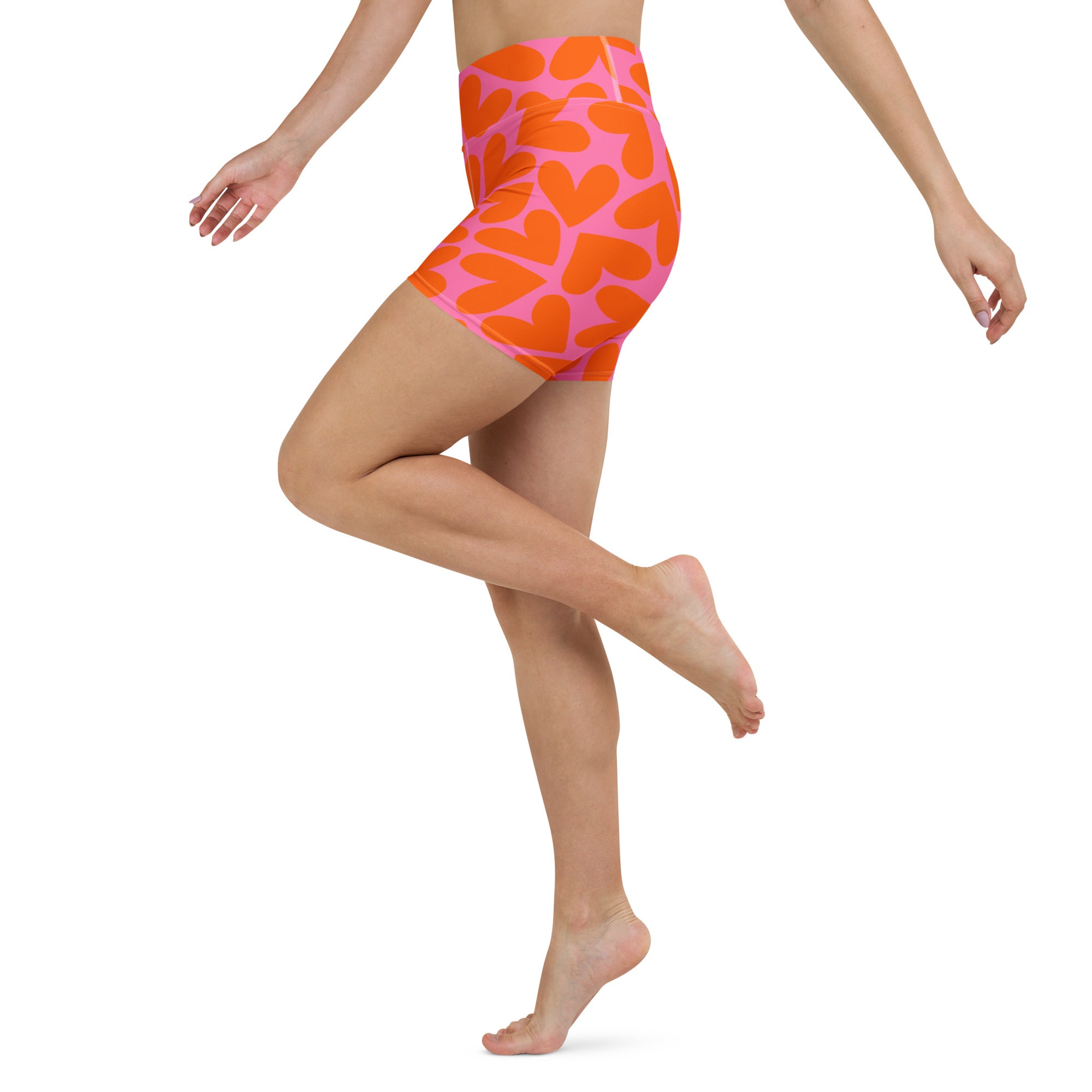 Colorful short yoga shorts with orange and pink hearts print, left side