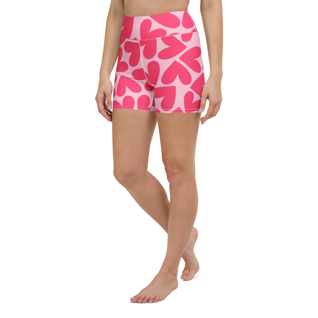 Woman wearing pink floral patterned shorts on a white background