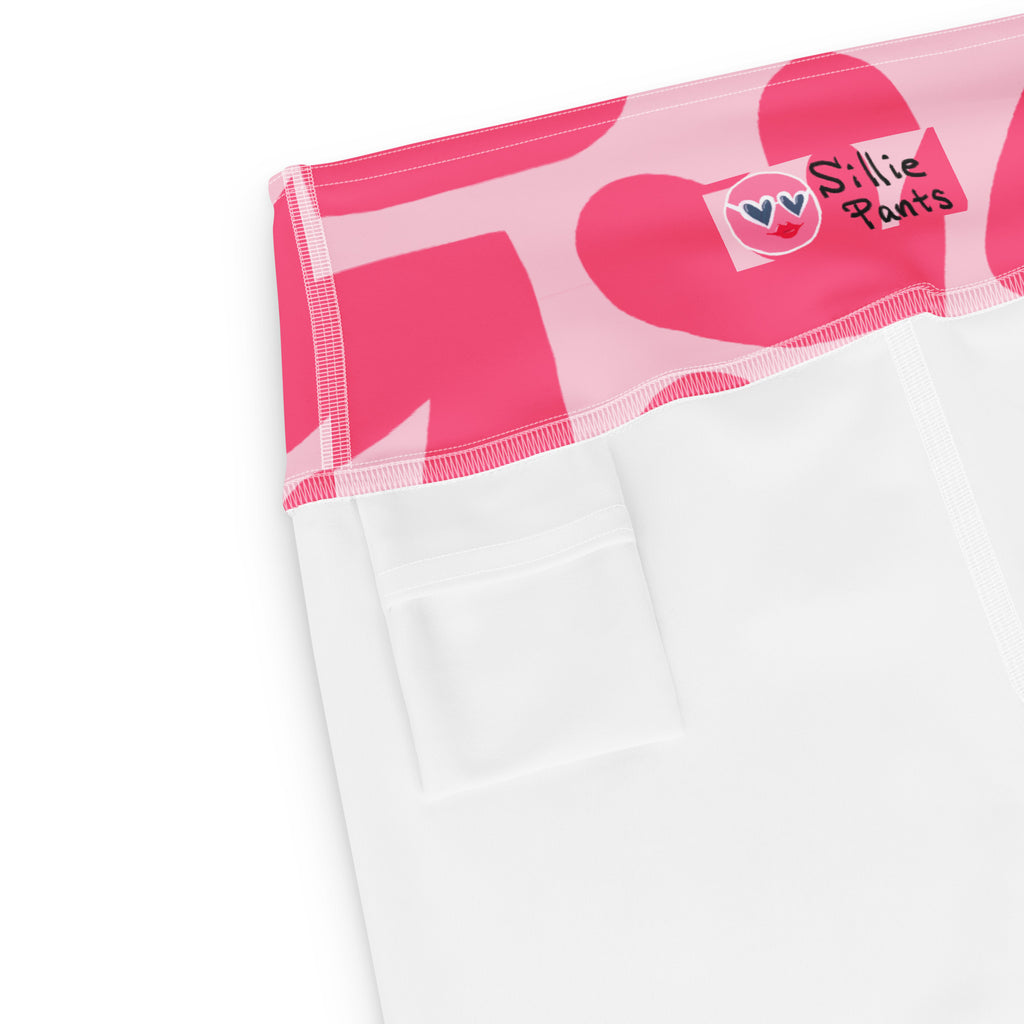 Yoga shorts with pink hearts print and small back pocket at the waistband on a white backgroundProduct mockup