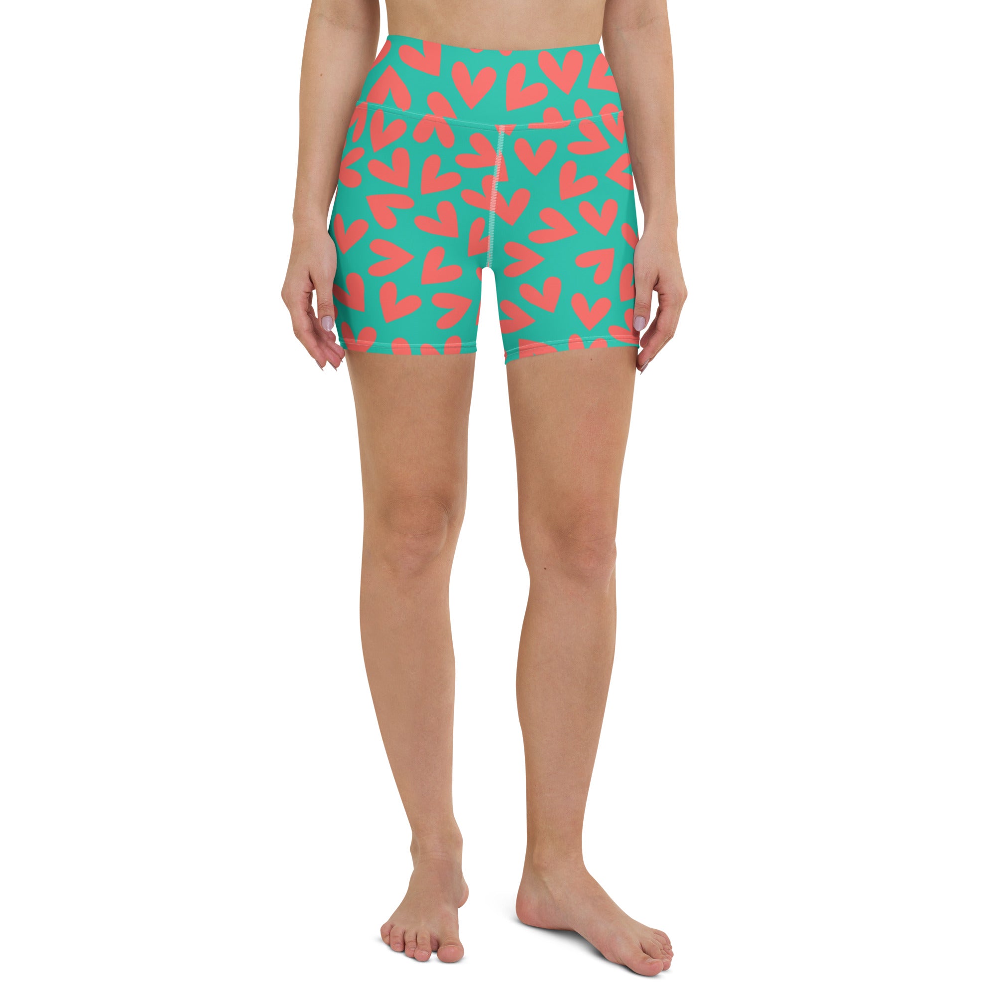 Colorful yoga shorts with teal and coral hearts print front view