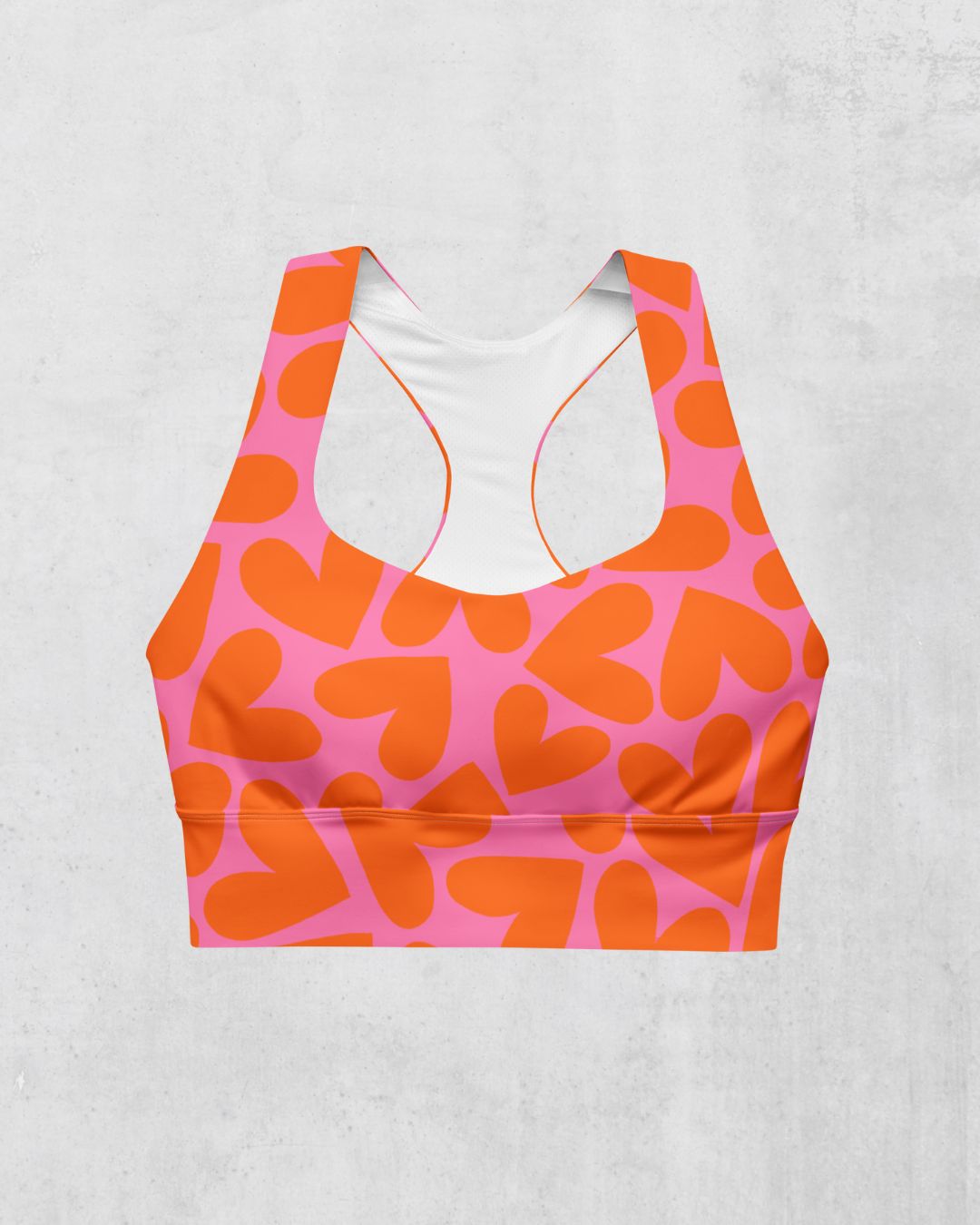 Orange and pink heart-patterned sports bra, front view