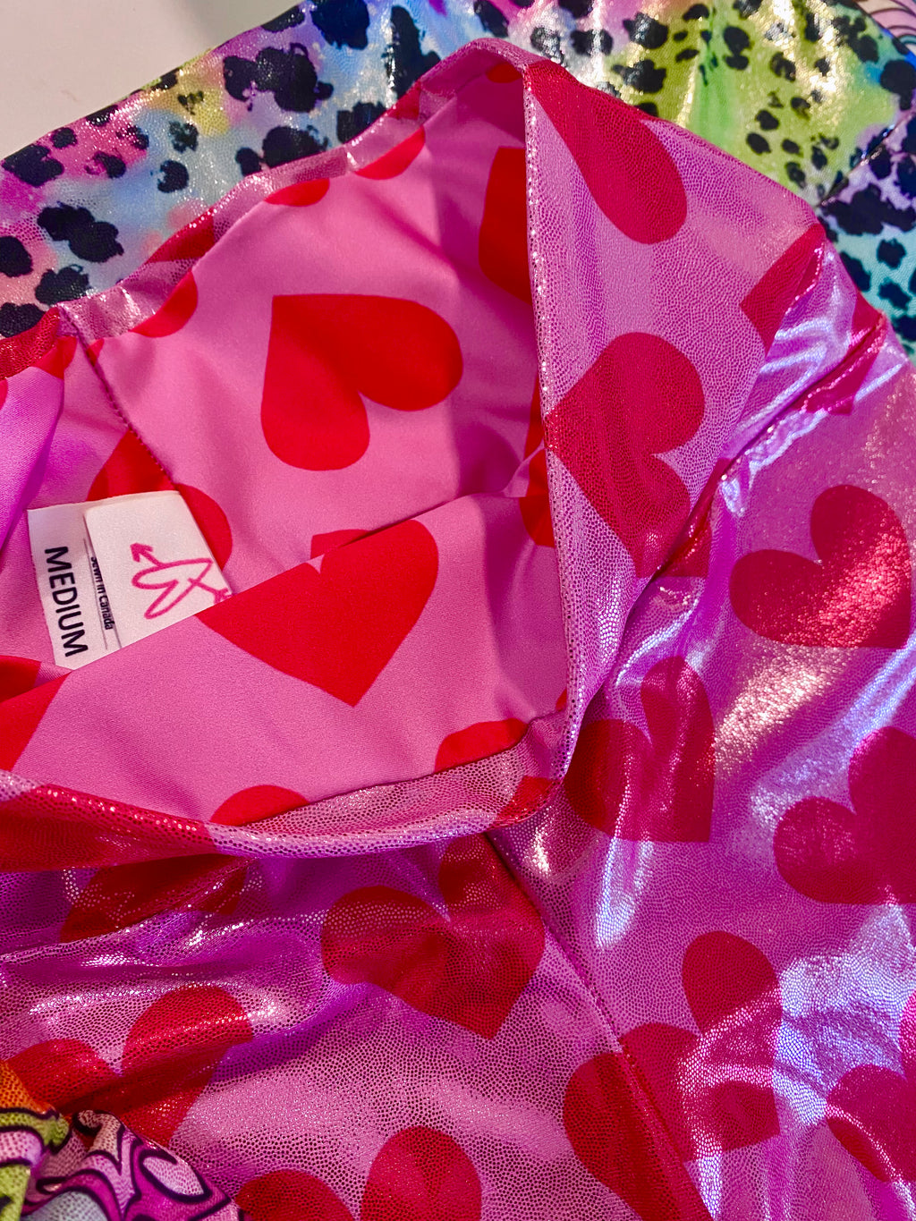 Pink glitter shorts with hearts, showing the label inside the waist band
